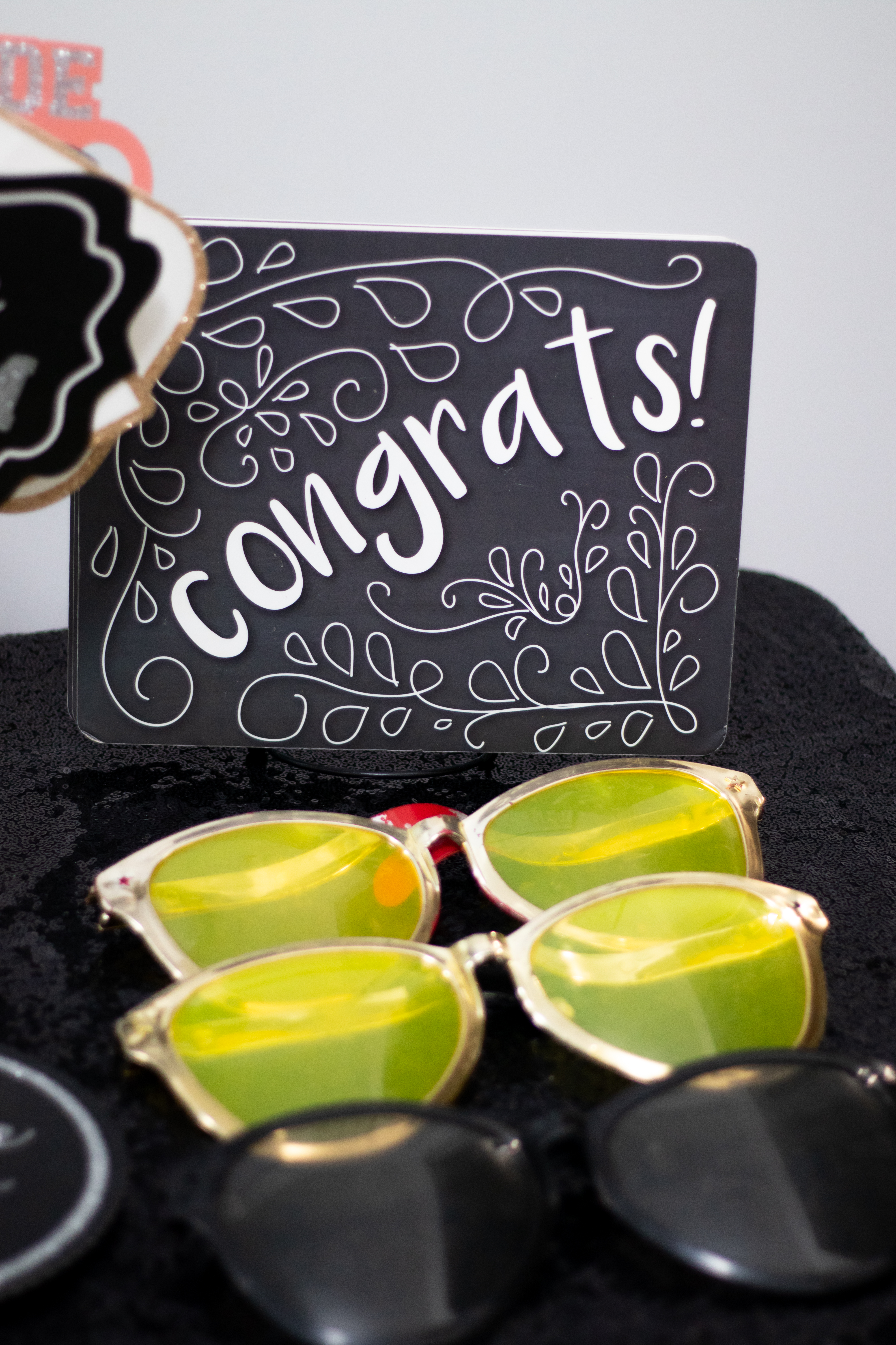 Festive Photos props — congrats sign and sunglasses
