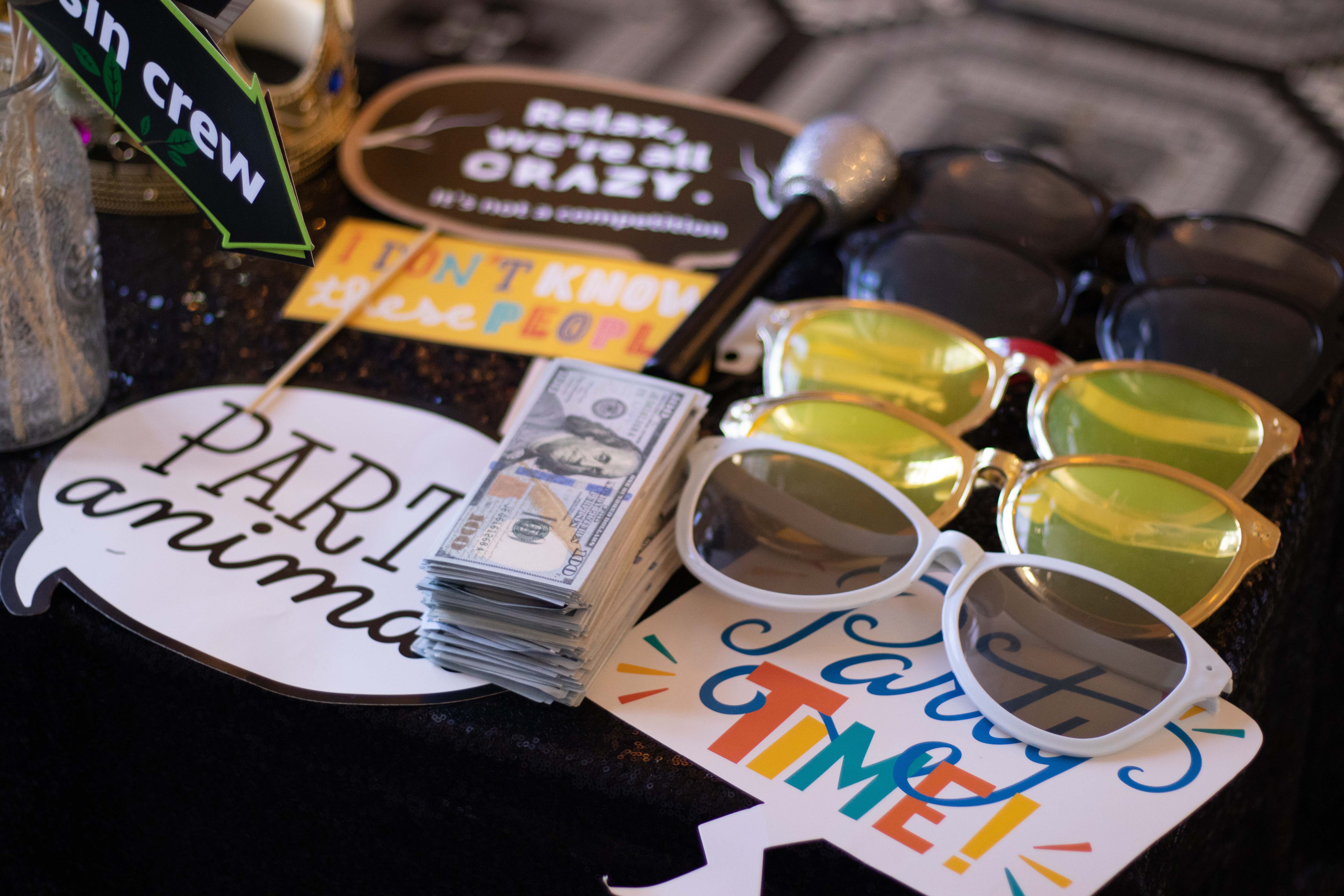 Festive Photos prop table — party animal signs and glasses